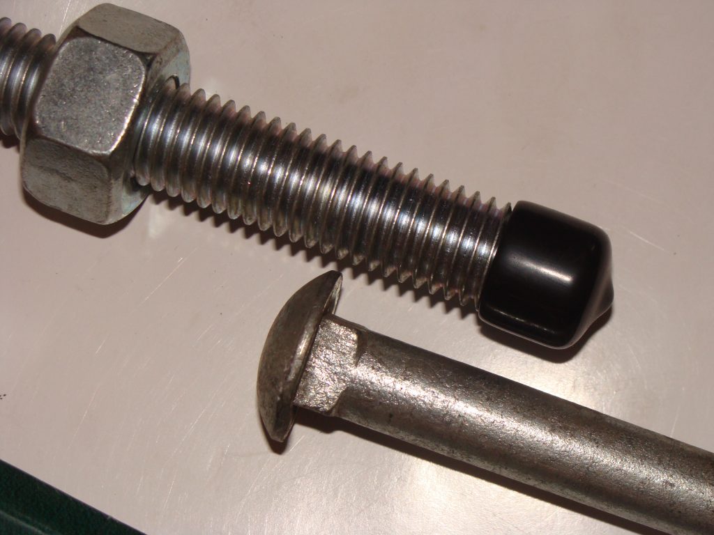 Carriage bolt with nut and plastic end cap assembled
